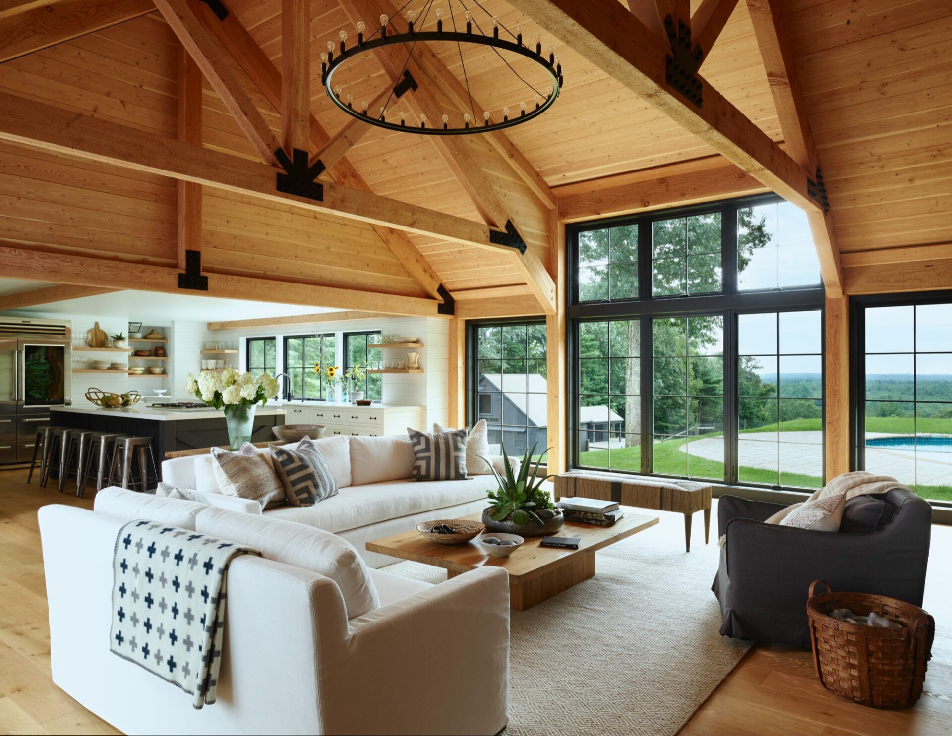Timber-framed great room in a farmhouse renovation by Benjamin Nutter Architects
