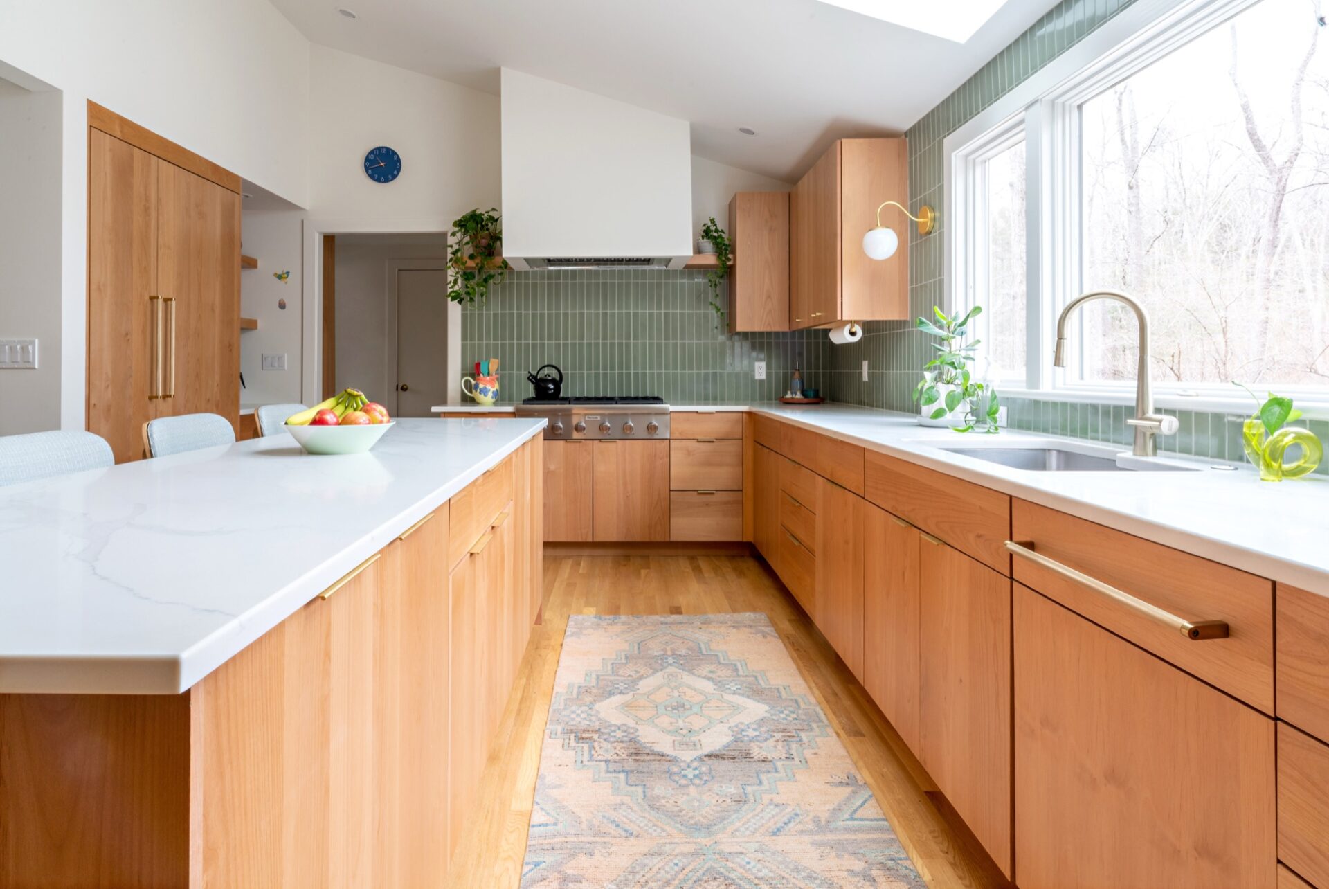 Wood-cabinet kitchen with a green tile backsplash by Heartwood Kitchens