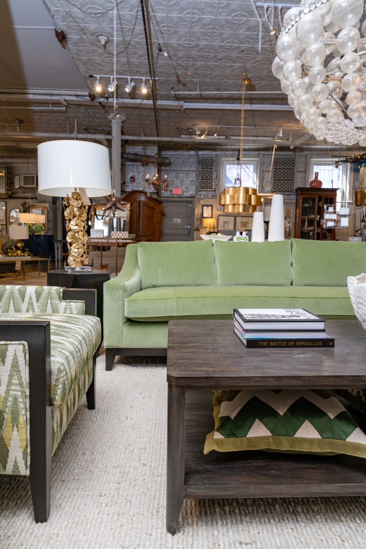 Green velvet sofa and upholstered chairs in the Zimman's showroom in Lynn
