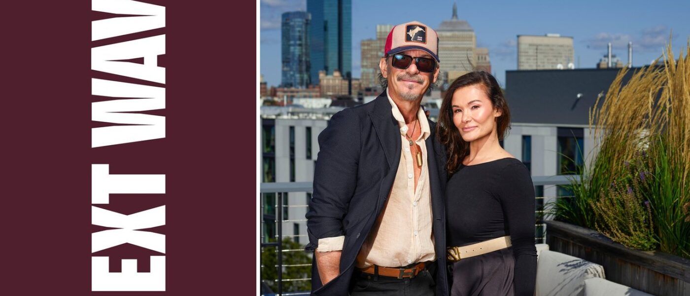 Marc Harris and Maria Lekkakos stand on a Boston rooftop beside vertical Next Wave lettering on maroon.