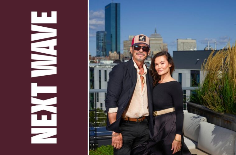 Marc Harris and Maria Lekkakos stand on a Boston rooftop beside vertical Next Wave lettering on maroon.